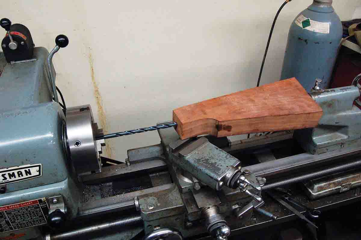 The easiest way to drill the stock bolt hole is by using a lathe.
